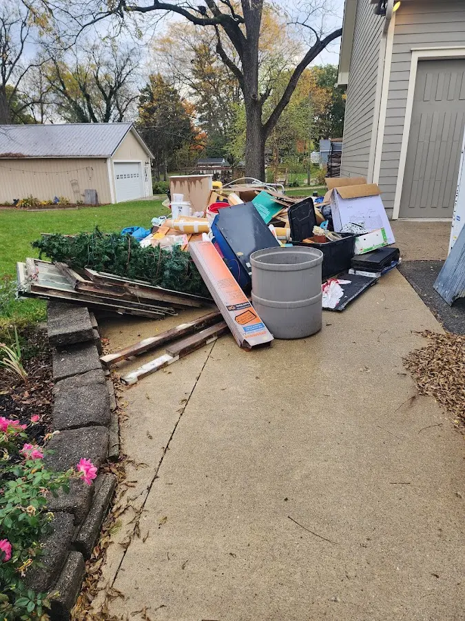 Dumpster being loaded with debris for Roofing Dumpster Rental in Decatur